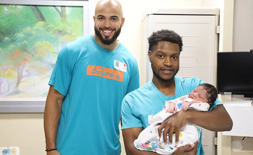 NFL player Julian Hill with baby Kaison Moody