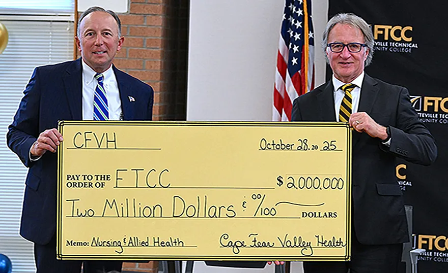 Cape Fear Valley CEO Michael Nagowski and FTCC President Dr. Mark Sorrells with a ceremonial check for CFVH’s historic donation to FTCC’s Nursing and Allied Health programs.