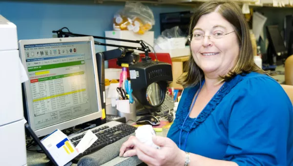 Woman looking at camera using technology