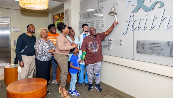 cancer patient ringing the bell to indicate they are cancer free